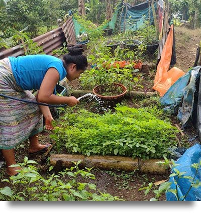 Photo of program participant with her permaculture garden.